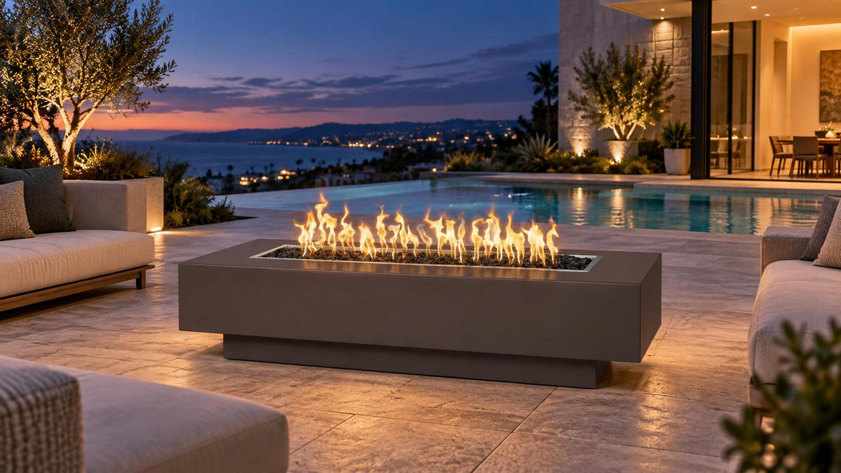 The Outdoor Plus Coronado metal fire pit in a luxury poolside patio setting